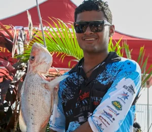 Participant holding a fish during the Northern Territory Coopers Blue Water Classic event campaign.